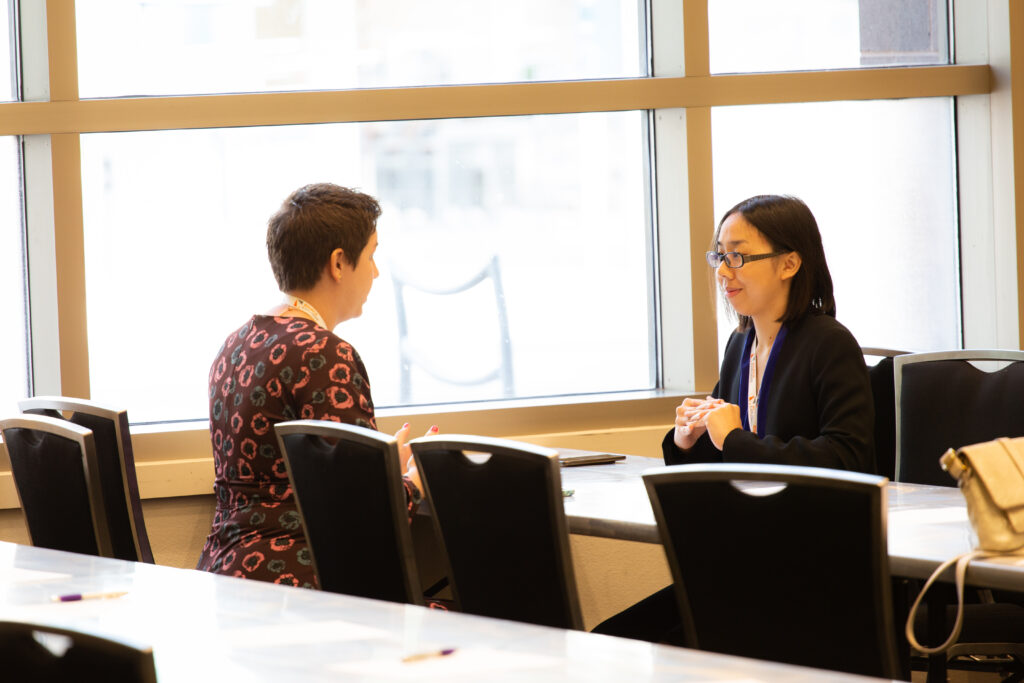 An image of a life science professional speaking with a grad student. Become a member and attend events to make connections like these today.