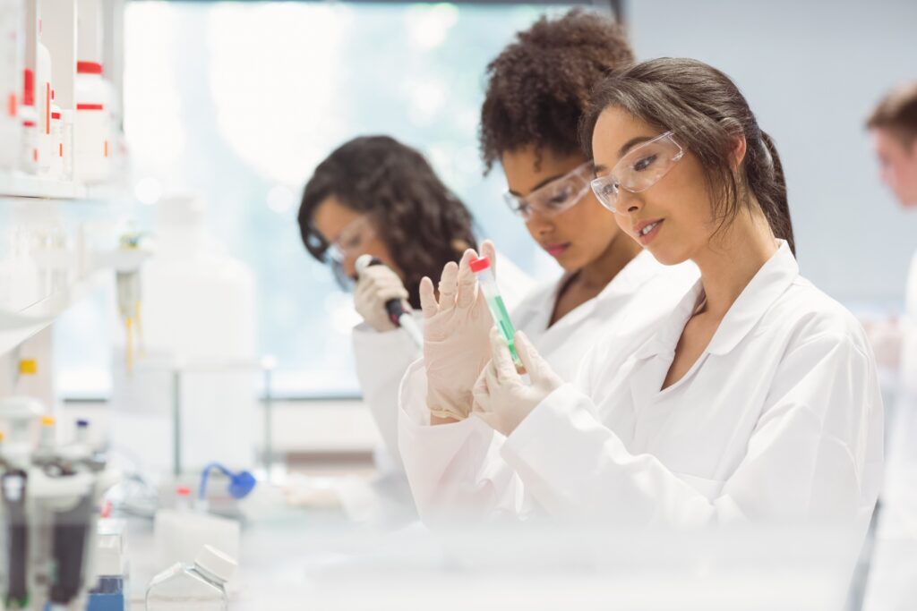 An image of scientists working in a lab. The woman at the forefront has brown hair tied back into a ponytail. As professionals, founding memberships would be perfect for them.